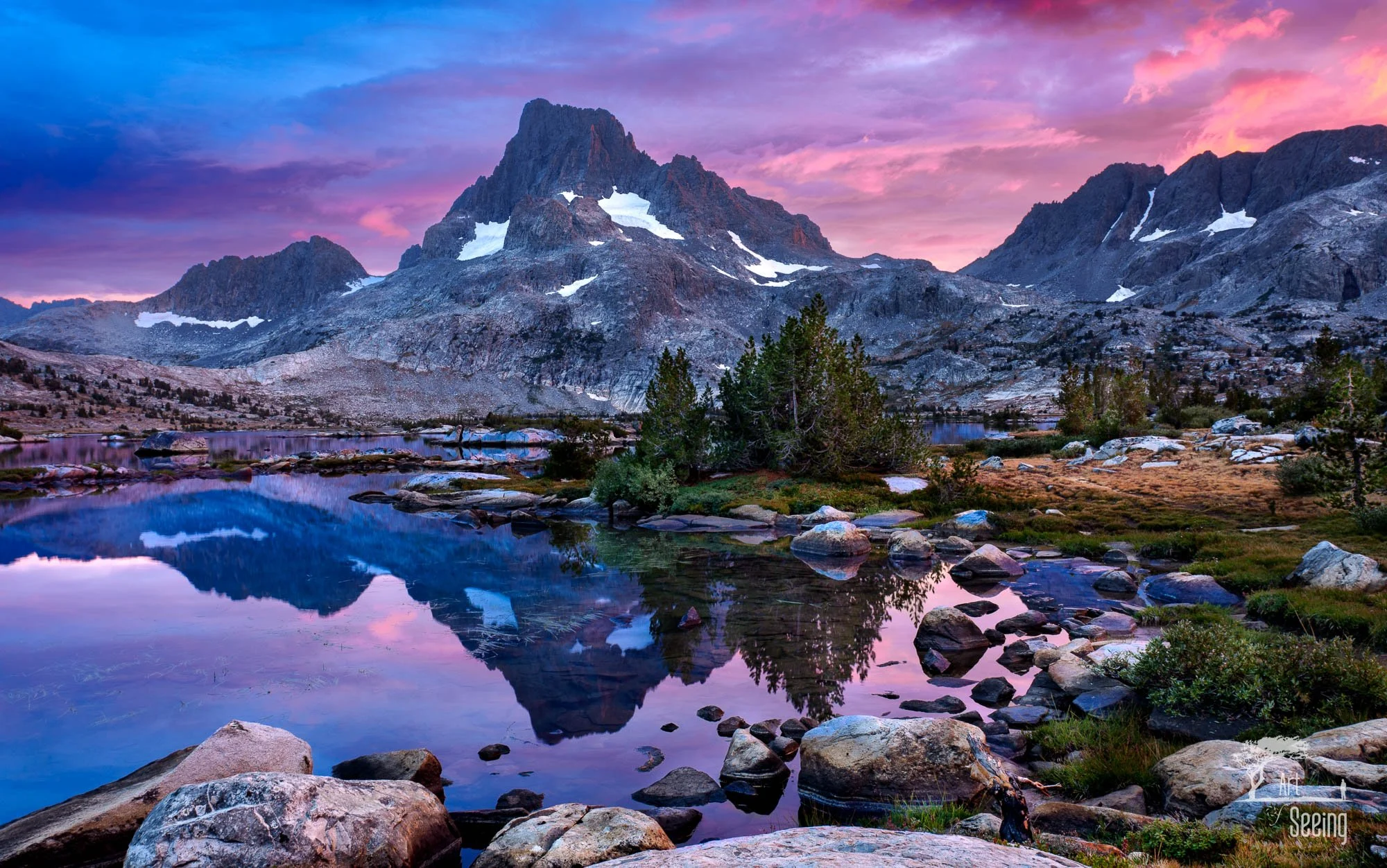 Pink sunset clouds over a Sierra Nevada lake and peaks, Ansel Adams Wilderness