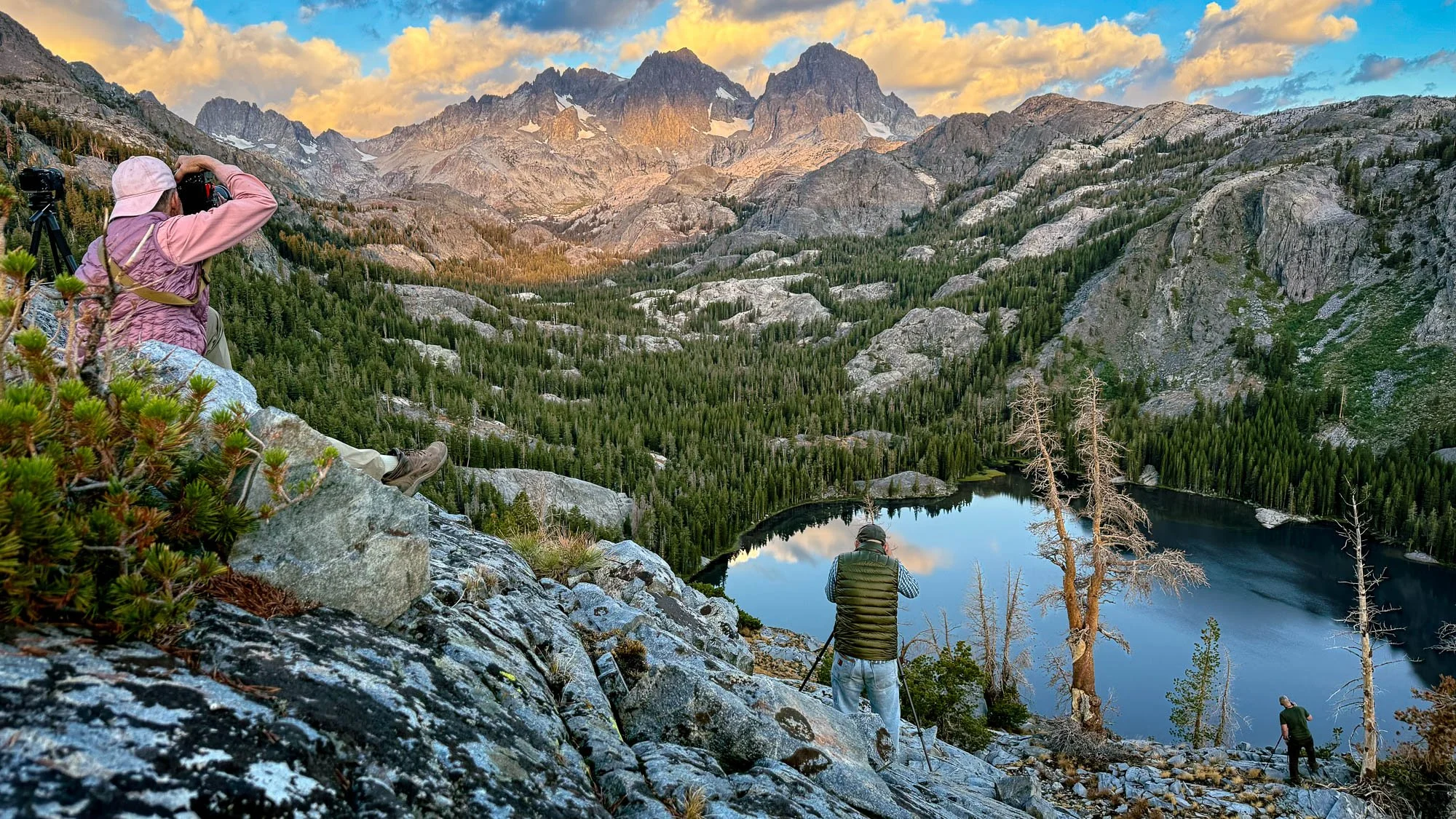 Photographers above an alpine lake basin in the Ansel Adams Wilderness, California