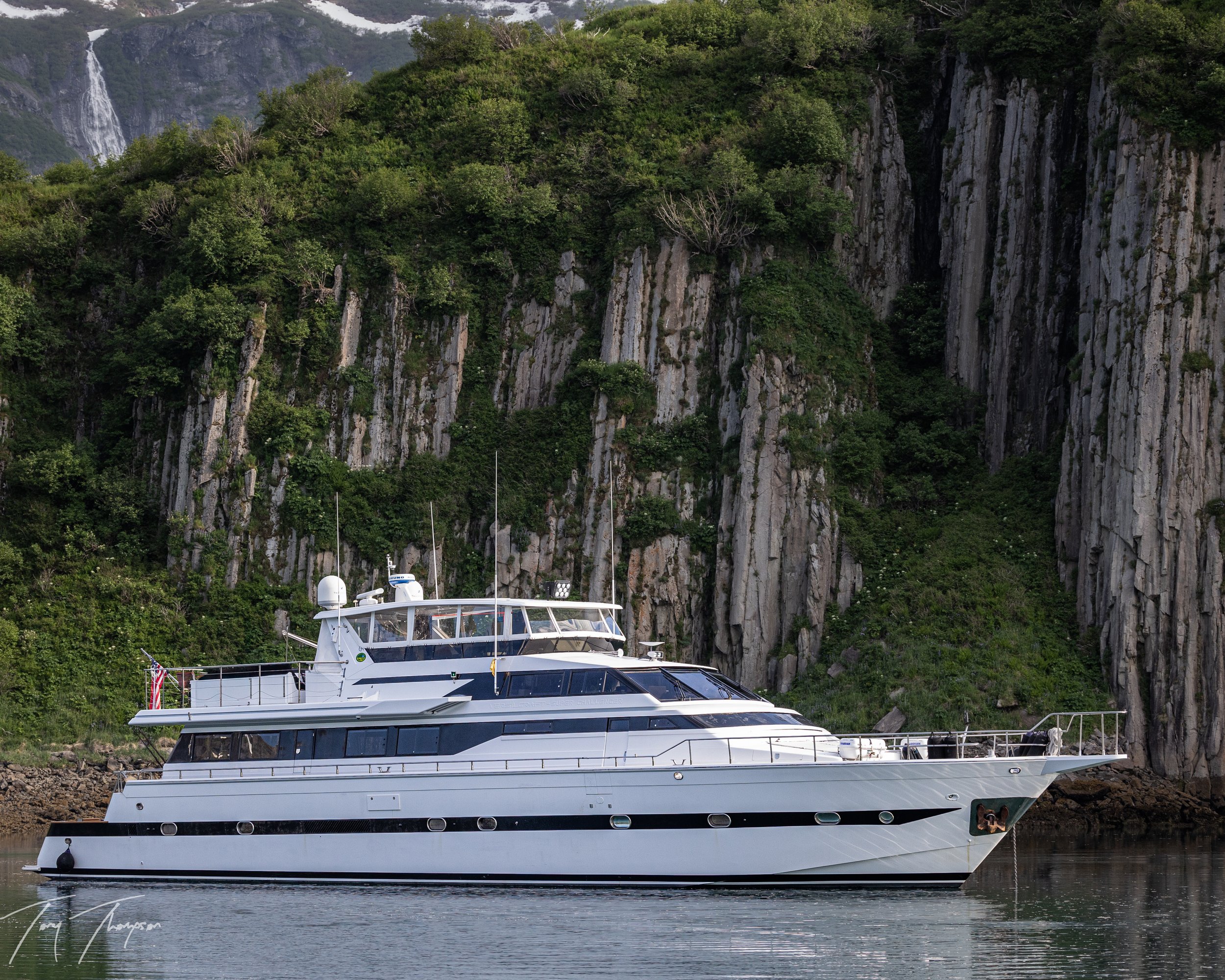The workshop's live-aboard boat anchored below cliffs, Katmai coast