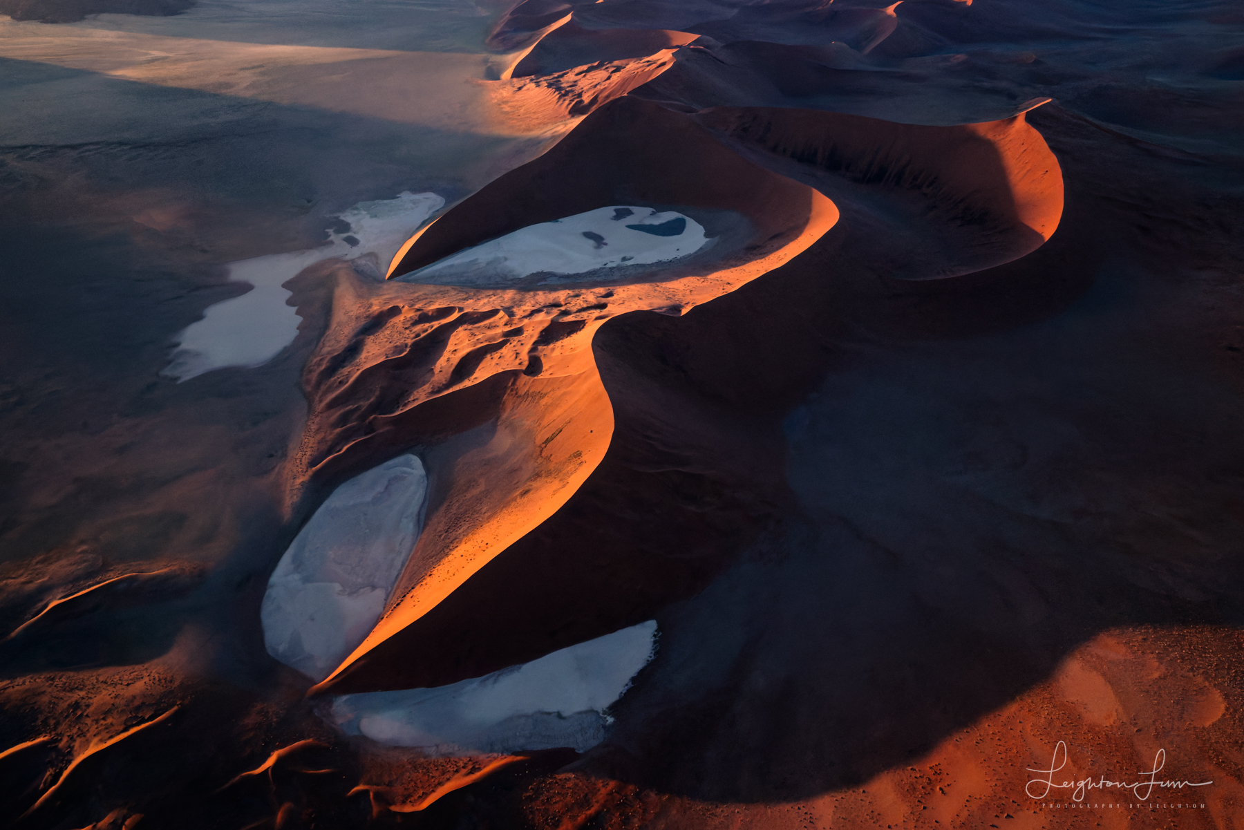 Aerial view of red Namib desert dunes and white salt pans at sunrise — Namibia photography workshop