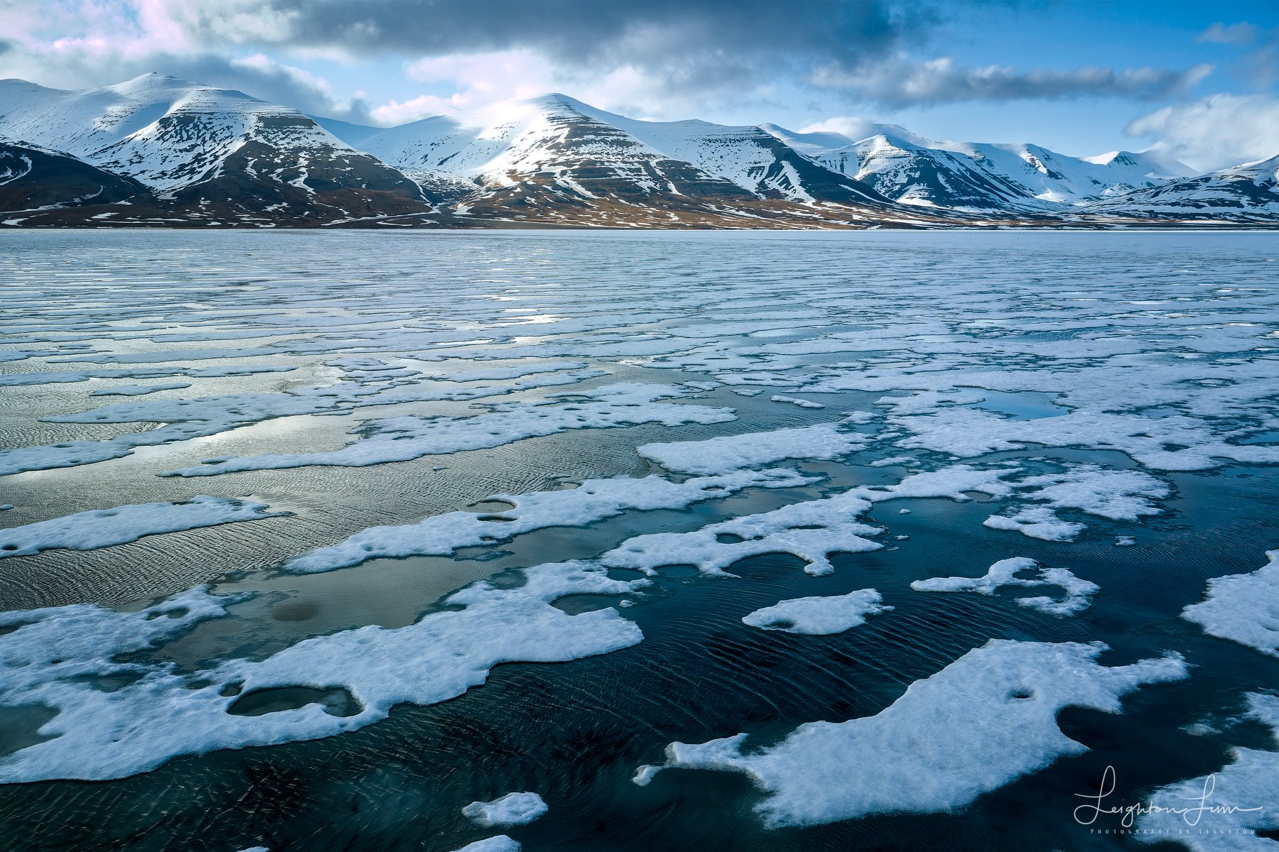Broken sea ice and snowy mountains, Svalbard, Norway