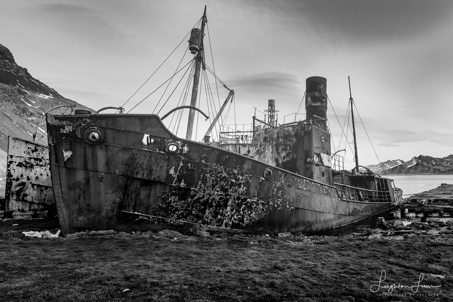 Rusting whaling ships beached at Grytviken, in black and white